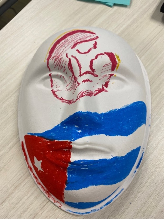 Figure. My mask from Dr Stephen’s workshop shows the Cuban flag, which represents my heritage, and the women’s health symbol, which represents me as a mother and my love for women’s health.