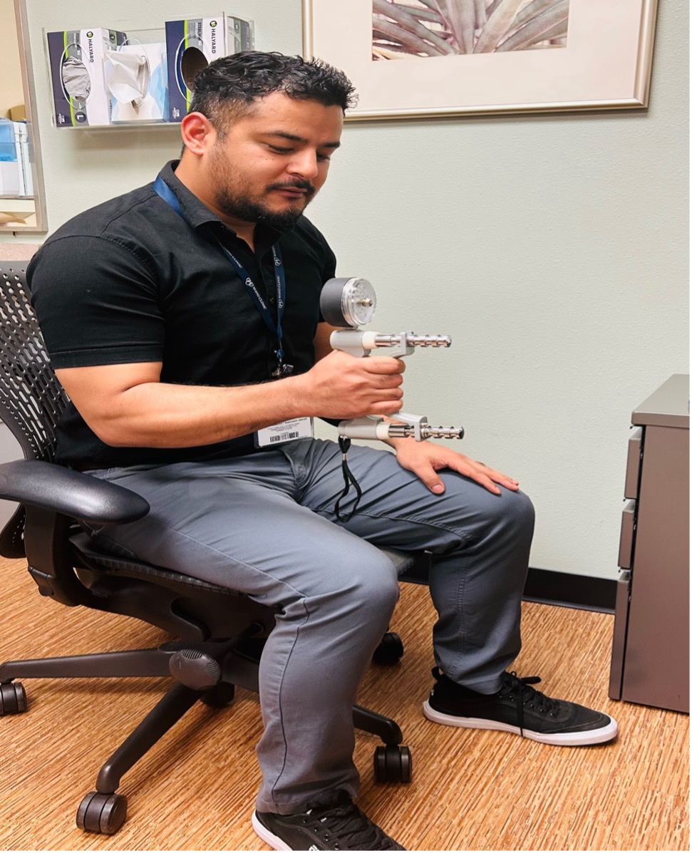 Physician demonstrating how to use a calibrated handheld dynamometer