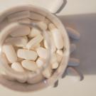 White pills in a bottle. 