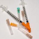 Syringes with different colored caps. 