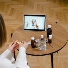 A woman speaking to a doctor using a tablet. 