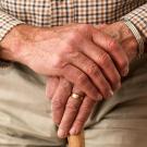 older man clasped hands