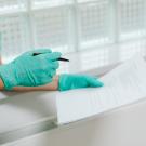 Medical professional with patient forms. 