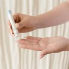 Person pricking their finger with a glucose monitor