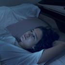 Teenager lying in bed in the dark 
