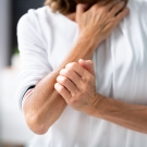 a woman itching her arm