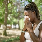 woman blowing her nose 