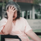 woman with head in hands