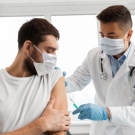 doctor giving man a shot