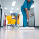 Health care worker cleaning a hospital floor