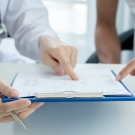 Doctor reviewing a file with a patient