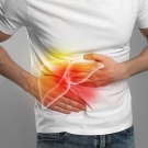 X-ray of man's liver, as he clutches it in pain. 