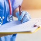 doctor completing paperwork