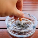 person putting out cigarette