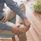 man holding his foot