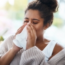 woman blowing nose