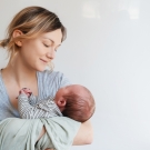 postpartum woman holding baby