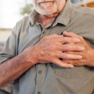 man gripping chest