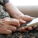Woman typing on a cell phone