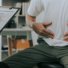 man holding his stomach