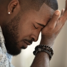 Man holding head in his hand