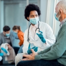 Masked doctor with masked patient