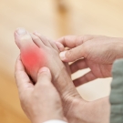 Person massaging a foot with gouty arthritis 
