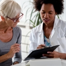 older female patient speaking to a doctor