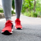 women's feet walking in running shoes