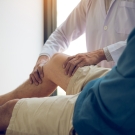 doctor examining knee