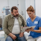 man with doctor looking at chart