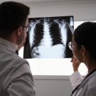 two physicians looking at a lung x-ray