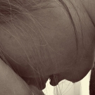 a woman holds her head in her hands