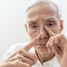 man touching nose