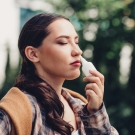 woman using nasal spray