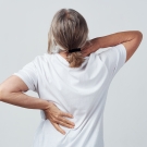 woman clutching back and neck