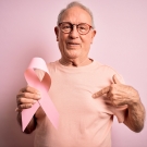 man holding breast cancer ribbon