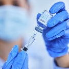 clinician preparing COVID-19 vaccine