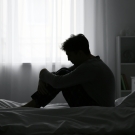 man sitting up in bed