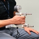 Physician demonstrating how to use a calibrated handheld dynamometer 