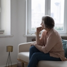 woman looks out window