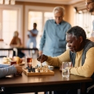 Happy seniors enjoying playing chess
