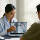 doctor pointing at image of lung