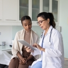 doctor talking to female patient