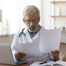 doctor looking through papers