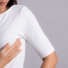 Woman performing self breast exam