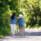 caregiver and senior with walker