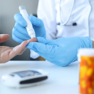 Doctor testing patient's blood sugar levels