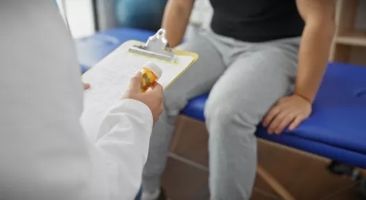 doctor with pill bottle