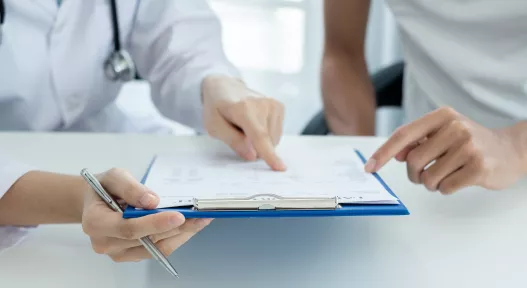 physician looking at chart